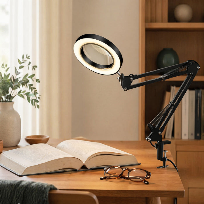 LED-loeplamp op een bureau naast een open boek en een leesbril